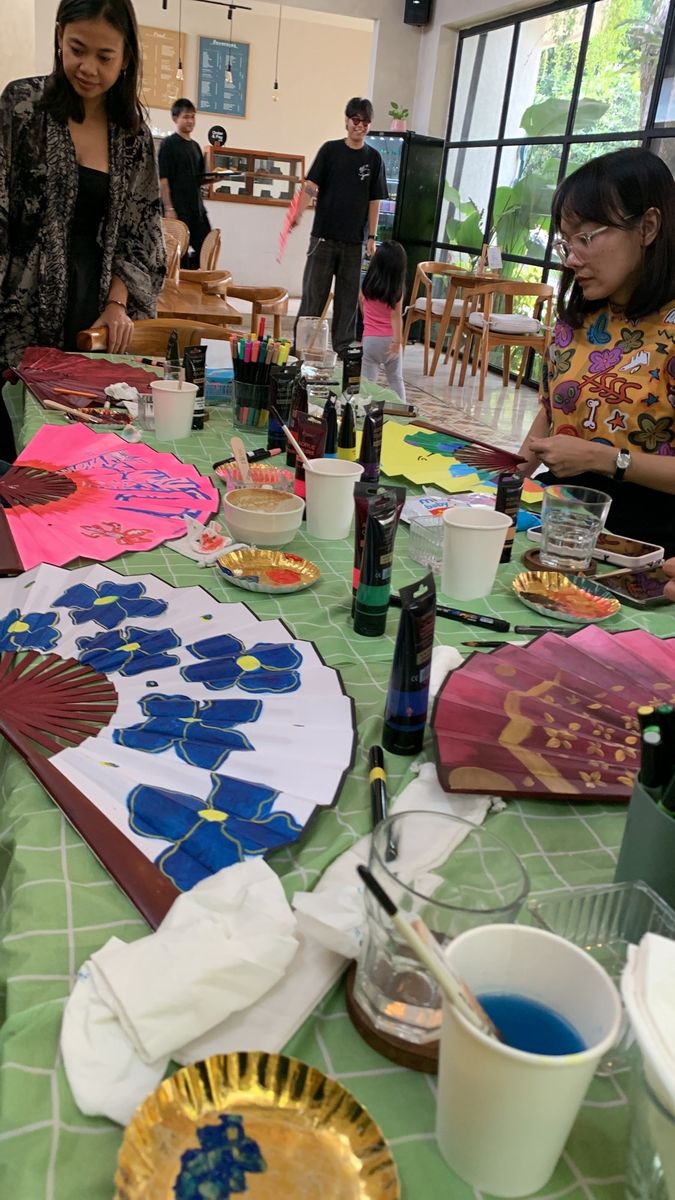 Painted fans with blue flowers on the table
